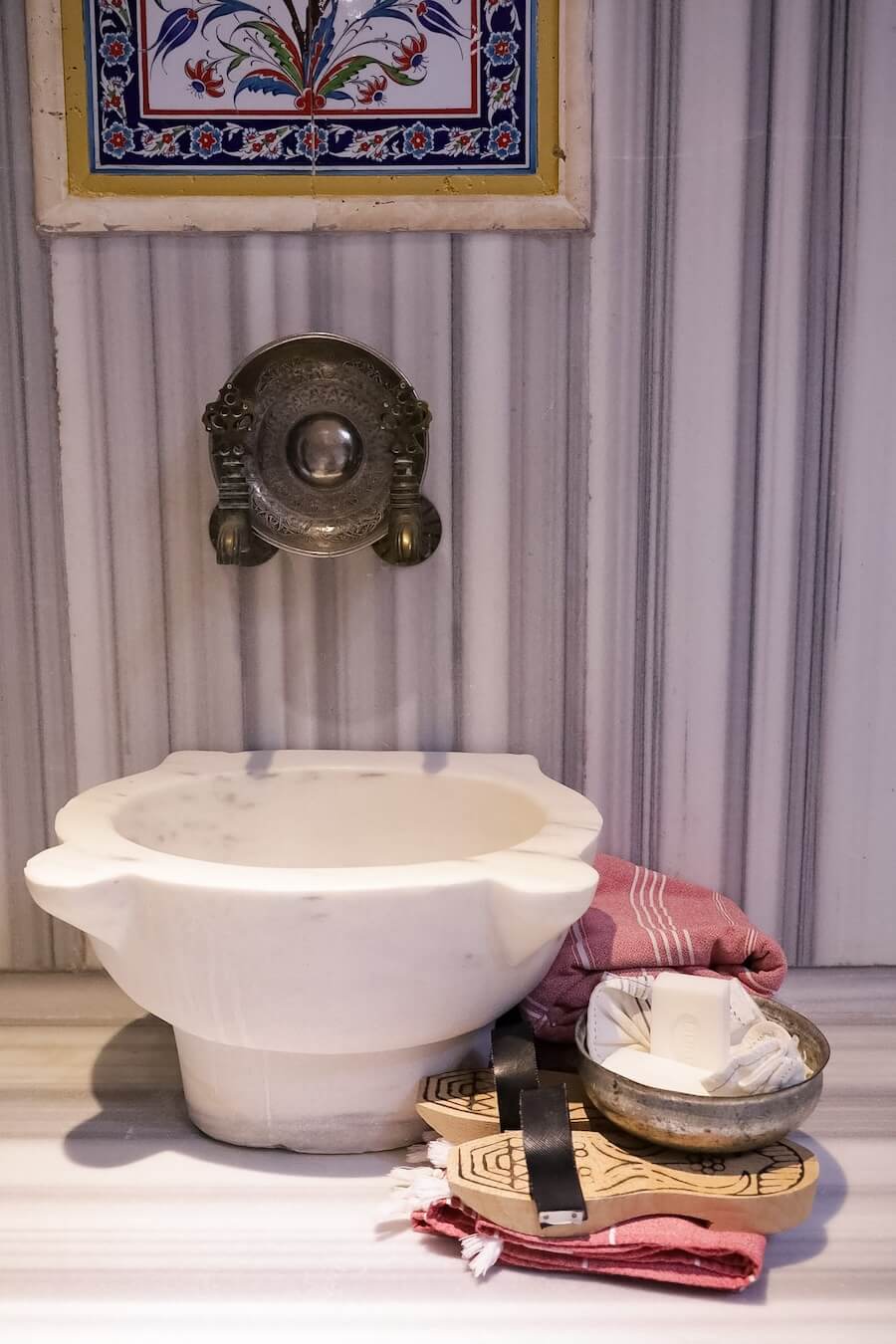 The marble basin, towel, shoes, soap and scrub prepared for a hammam, at one of the well known hammams in Göreme, Cappadocia.